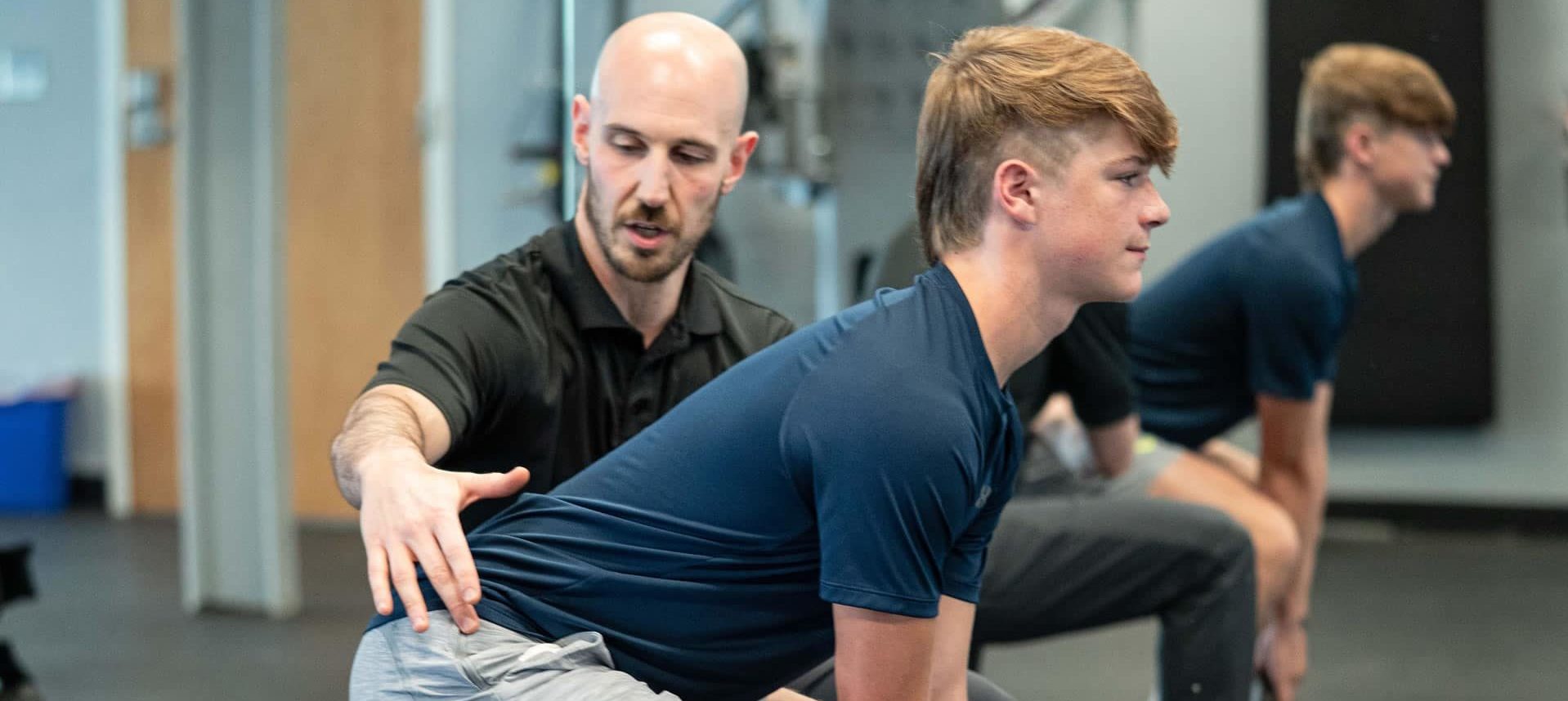 Dr, Cohen coaching a young man on exercise form