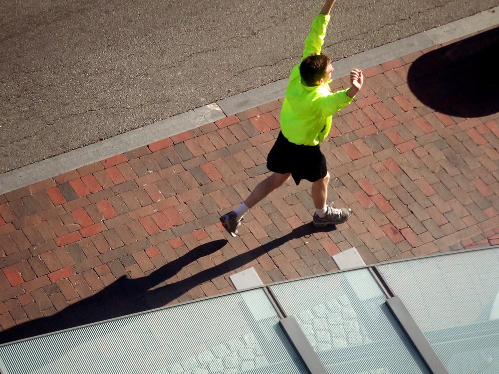 Runner with arms overhead