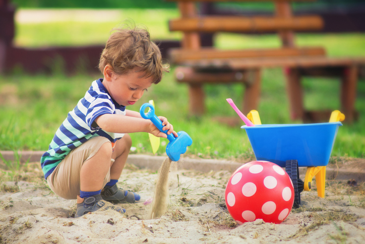 Young boy playing in the playground in summertime