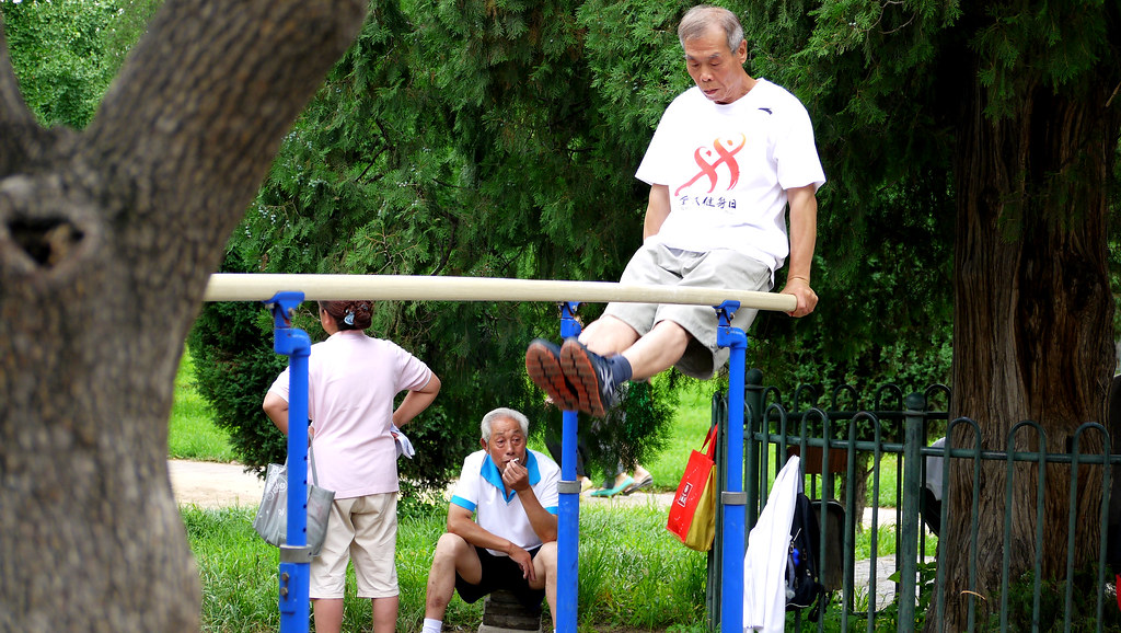 Older man on parallel bars