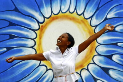 joyful woman in front of sun and sky illustration