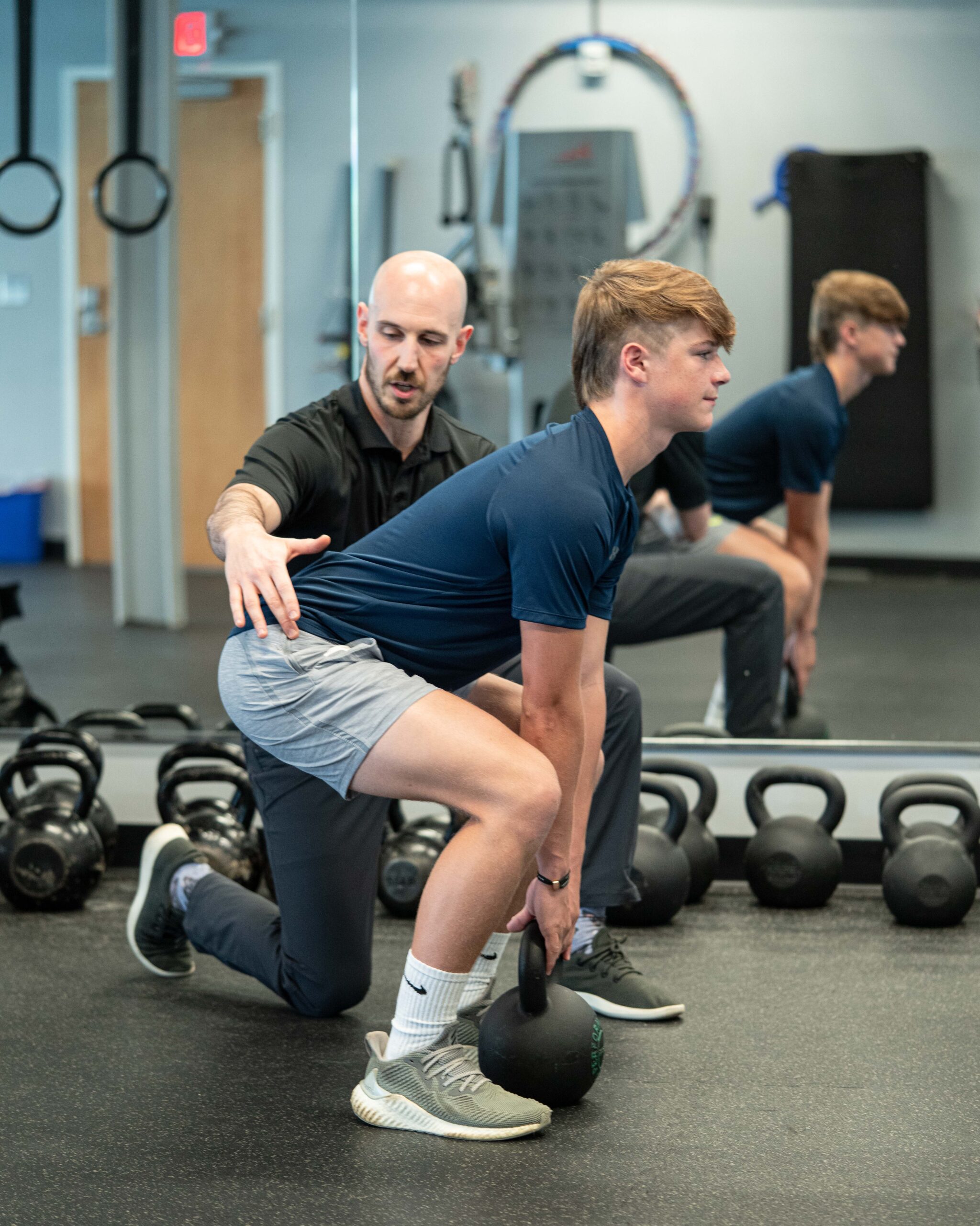 Zac coaching Jack on a deadlift