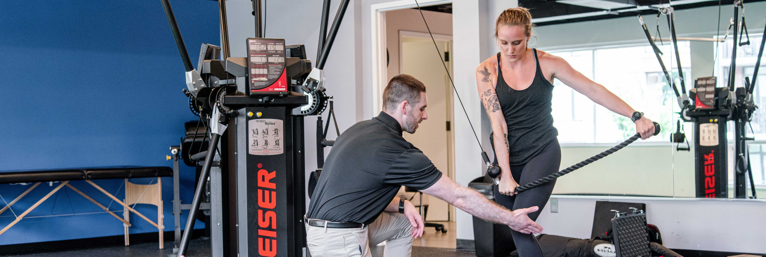 Cody coaching Melissa on a cable chop